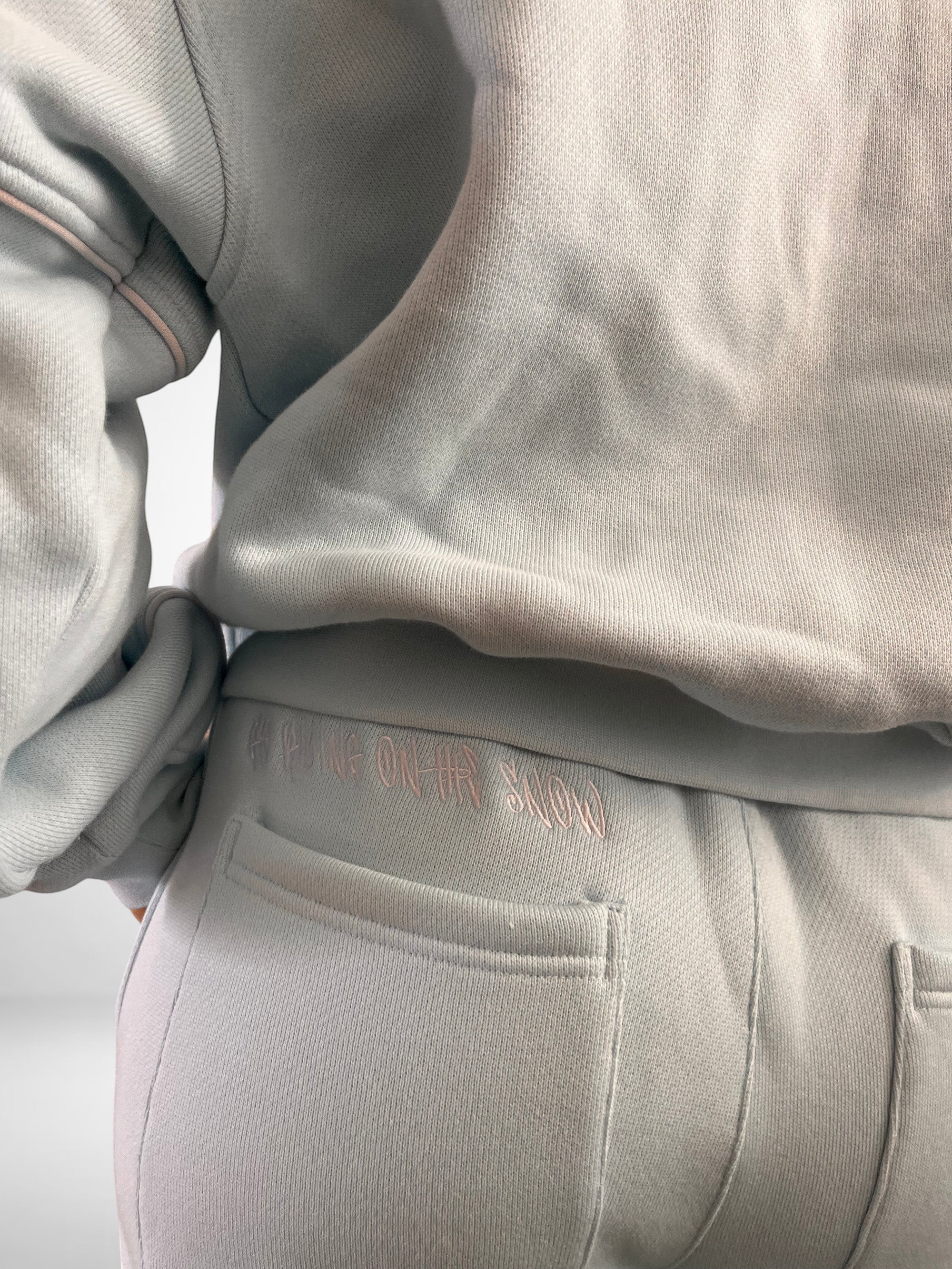 SLAYZ light blue oversized cotton blend jogging suit with embroidered text on back pocket.