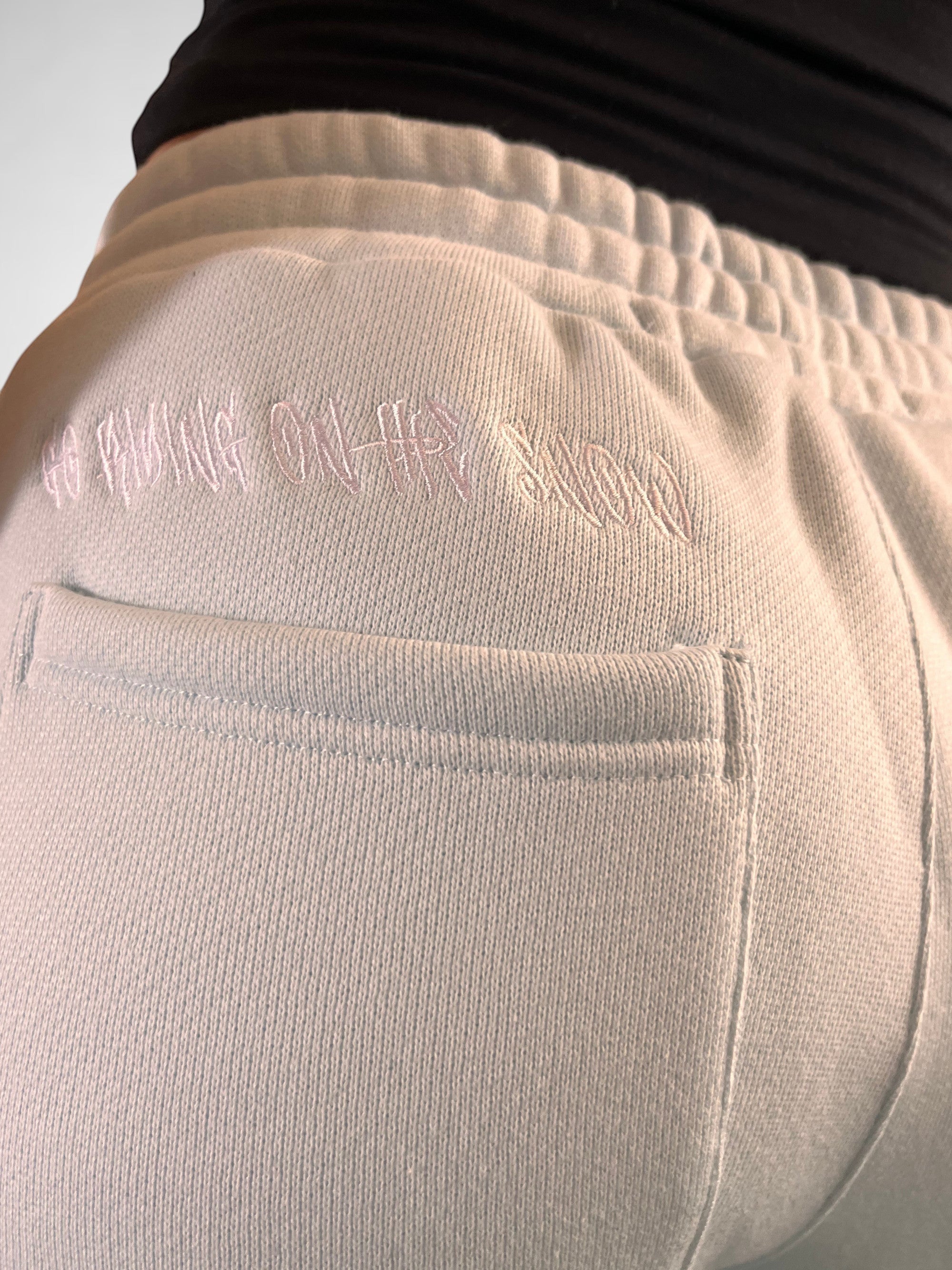 SLAYZ light blue relaxed fit sweatpants with embroidered text detail and drawstring waist.