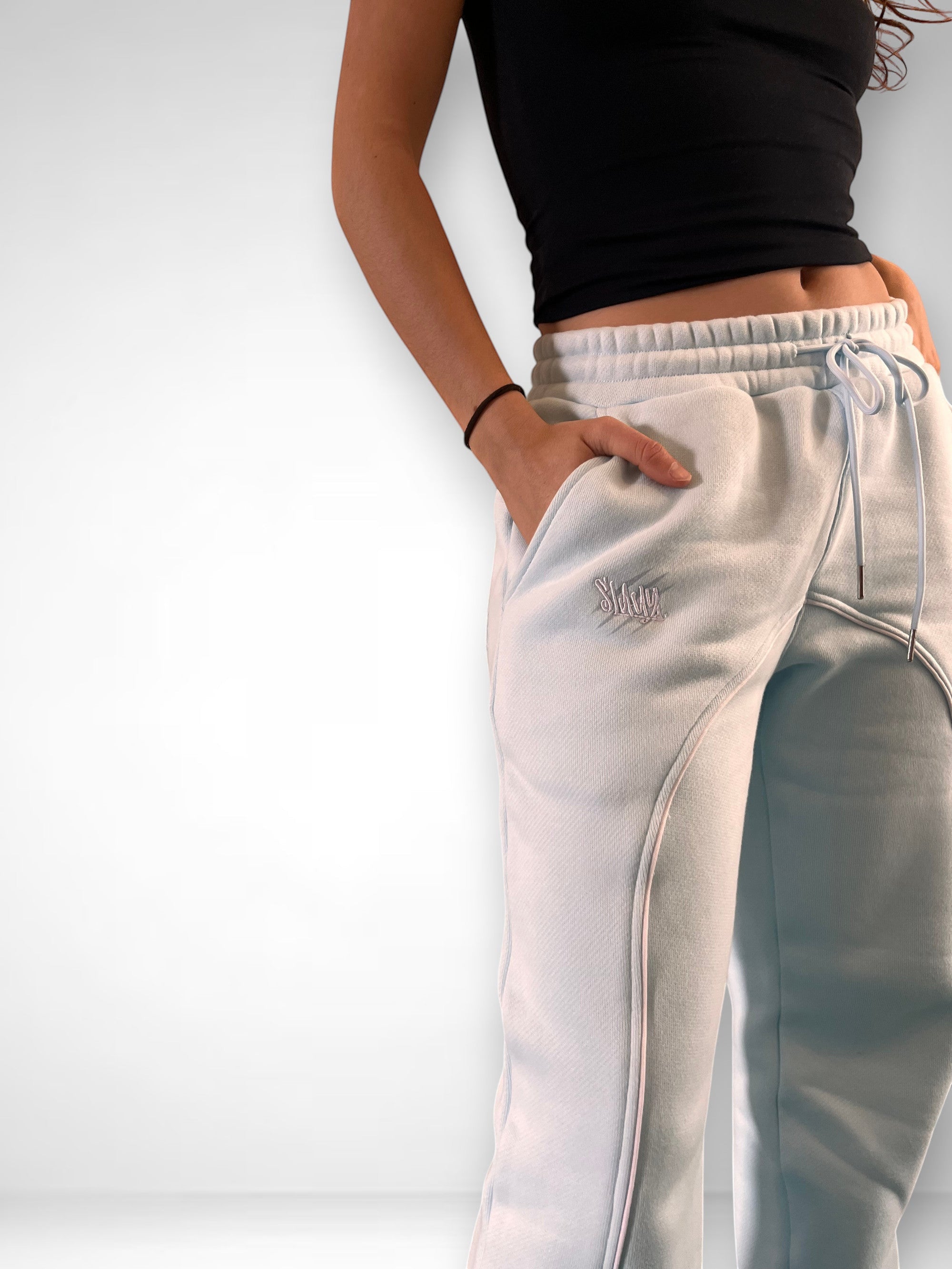 SLAYZ light blue relaxed fit sweatpants with drawstring waist and embroidered logo. Soft, comfortable fabric.